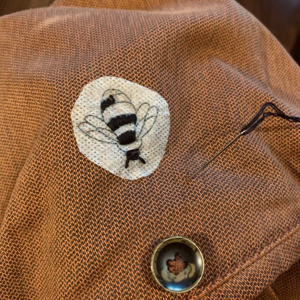 photo of partially embroidered bumblebee on satchel