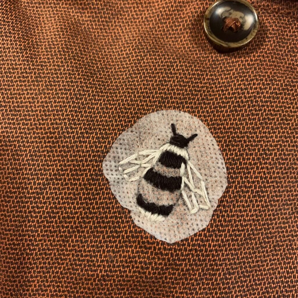 photo of partially embroidered bumblebee on satchel