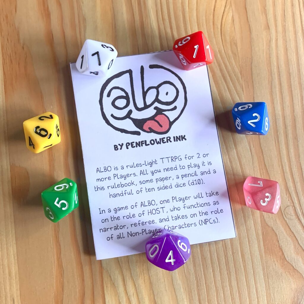 Photo of the printed and assembled Albo Pocket Version booklet, cover. Surrounded by colourful d10.