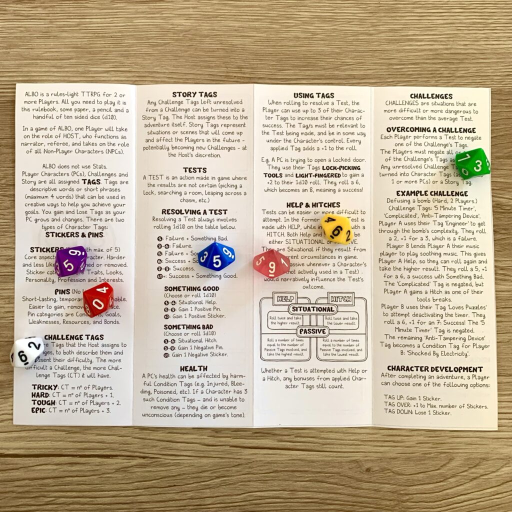 ALBO bookmark pamphlet, open, showing game rules. Colourful d10 dice for decoration.