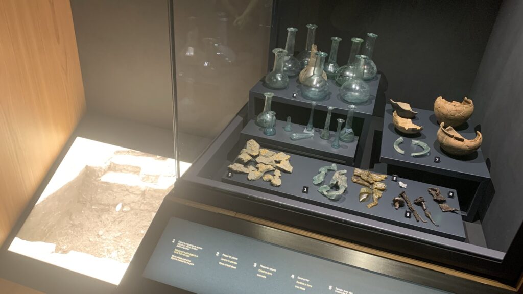 A collection of artifacts, including glass bottles and pottery fragments.