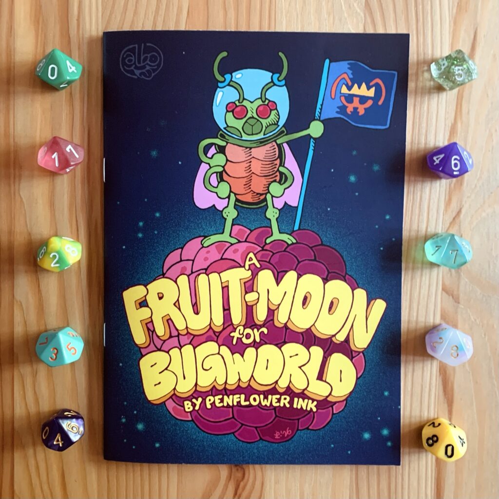 Photo of the print version of a Fruit-Moon For Bugworld, on a wooden surface, surrounded by colourful d10s. An insectoid astronaut plants the flag of Bugworld on the surface of a pink and purple berry-shaped moon.