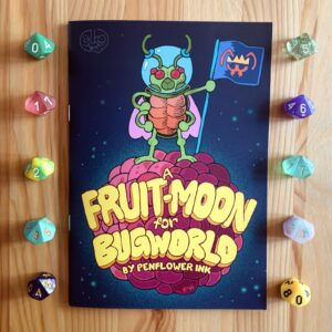 Photo of the print version of a Fruit-Moon For Bugworld, on a wooden surface, surrounded by colourful d10s. An insectoid astronaut plants the flag of Bugworld on the surface of a pink and purple berry-shaped moon.