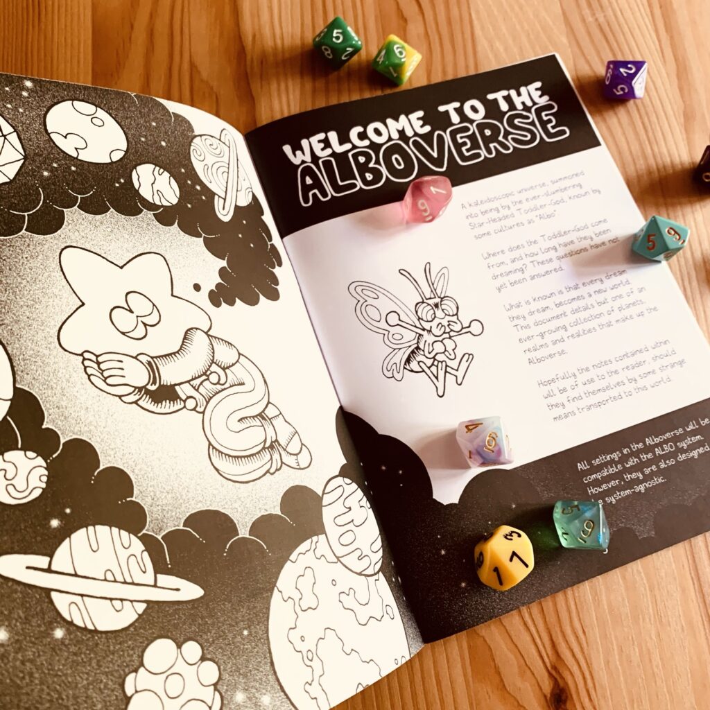 Photo of the interior pages of the print version: black and white traditionally illustrated, decorated with multi-coloured d10s.