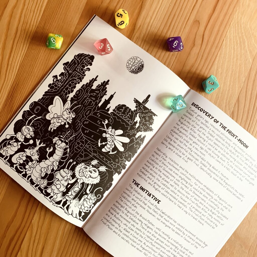 Photo of the interior pages of the print version: black and white traditionally illustrated, depicting a crowd of Buglins reacting to the sudden appearance of the Fruit-Moon above a city skyline.